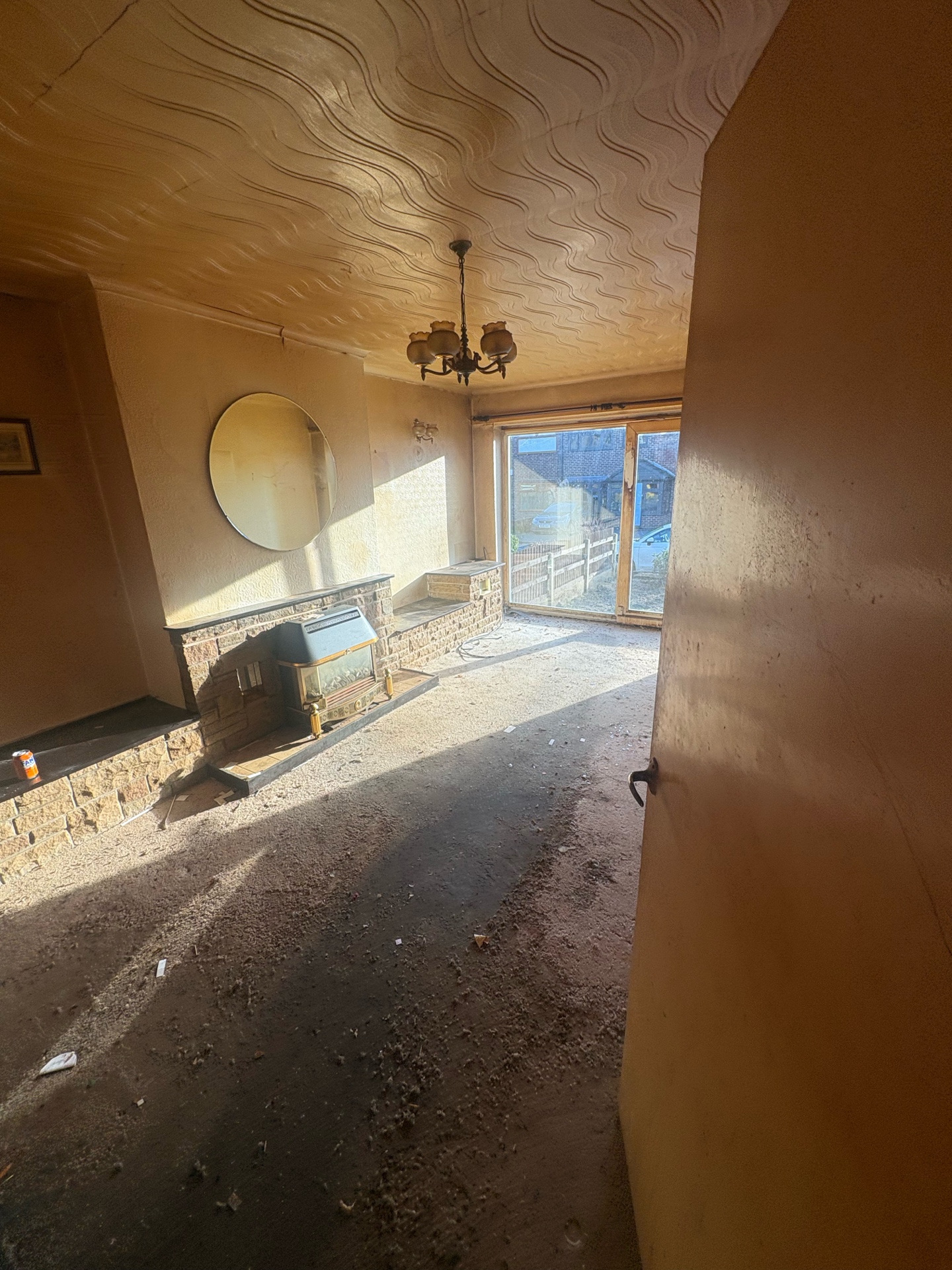 Property clearance — abandoned living room, stripped carpet and debris